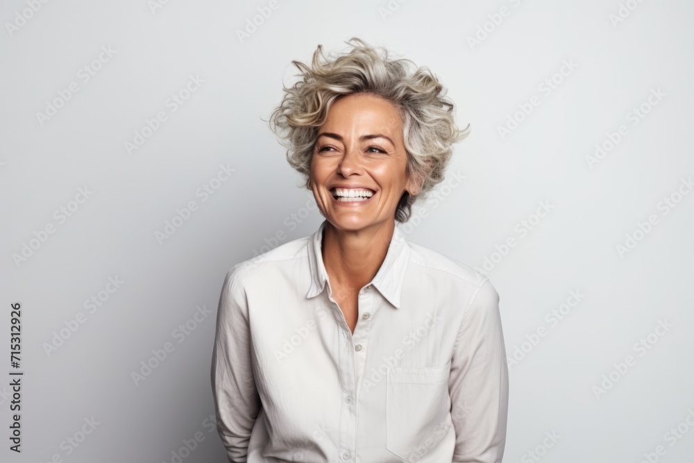 Portrait of happy mature businesswoman smiling and looking at camera. Portrait of happy mature businesswoman smiling and looking at camera.