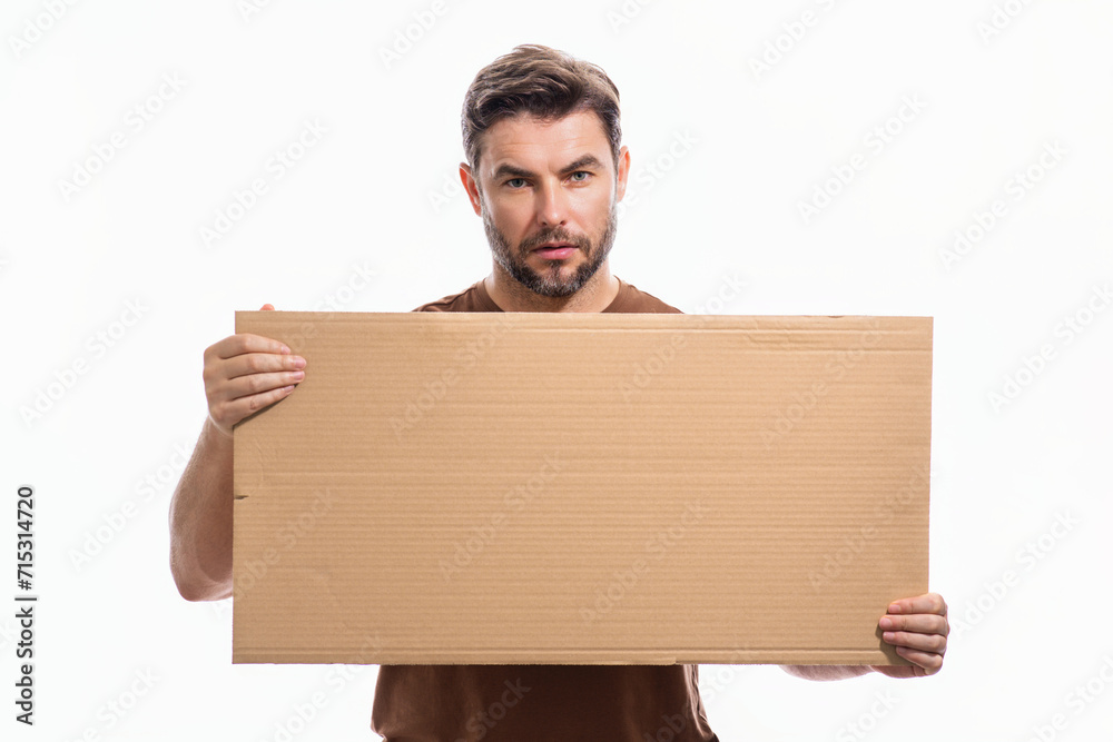 Handsome man holding empty board isolated on studio background. Guy showing blank signboard with copyspace. Idea offer. Your advertisement. Blank advertising board with empty space for text, mock up. Handsome man holding empty board isolated on studio background. Guy showing blank signboard with copyspace. Idea offer. Your advertisement. Blank advertising board with empty space for text, mock up.