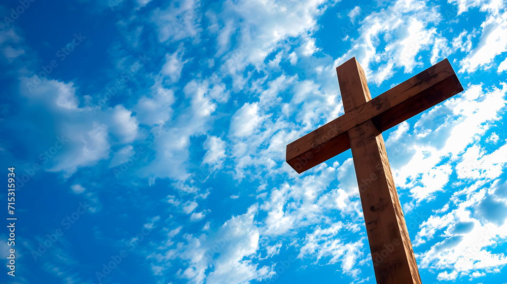 A wooden cross under a blue sky. Easter week