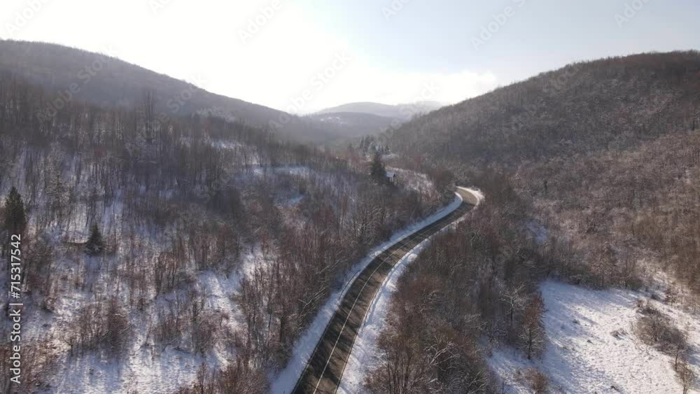 Travel journey transport and vacation concept High angle aerial view drone video on the road in mountain range with white snow in winter day near Knjazevac in Serbia nobody empty Travel journey transport and vacation concept High angle aerial view drone video on the road in mountain range with white snow in winter day near Knjazevac in Serbia nobody empty