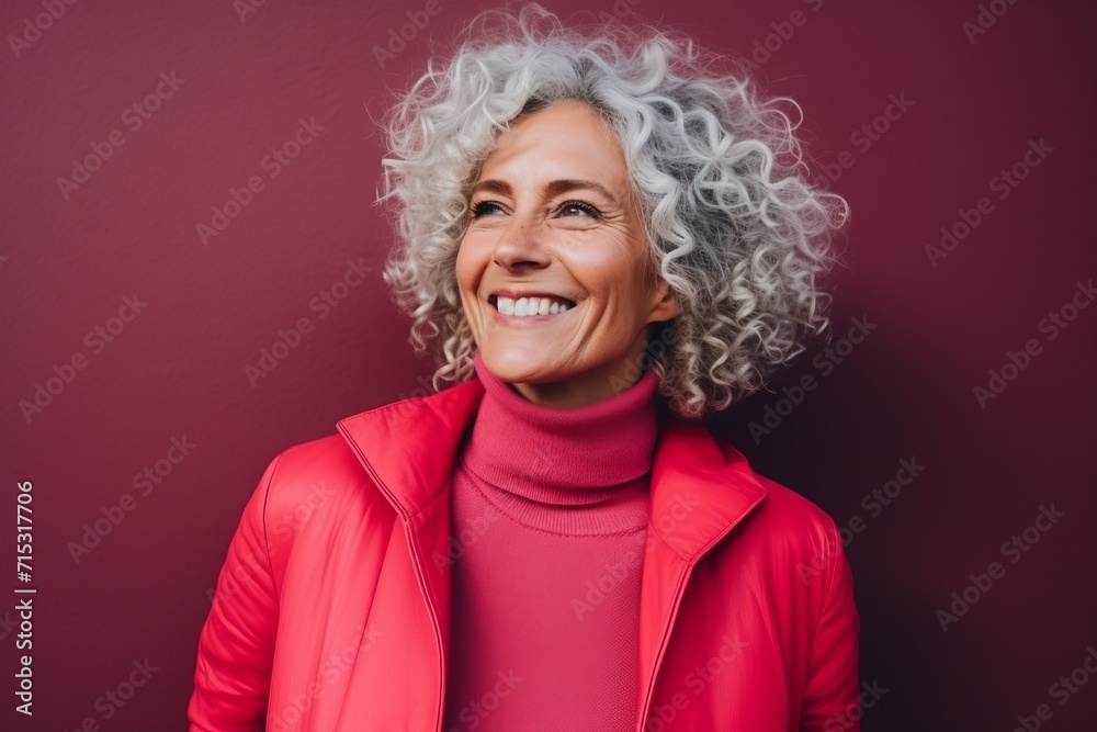Portrait of a happy senior woman with curly grey hair smiling at the camera Portrait of a happy senior woman with curly grey hair smiling at the camera