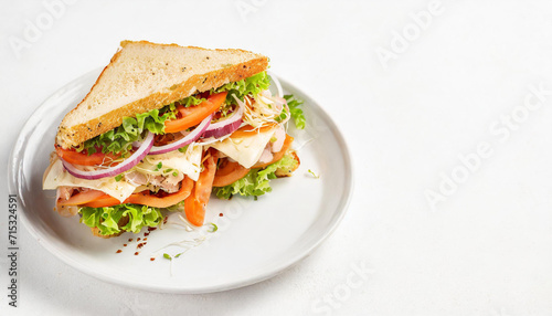 A perfect club sandwich served on a white plate and isolated against a clean white backgroun