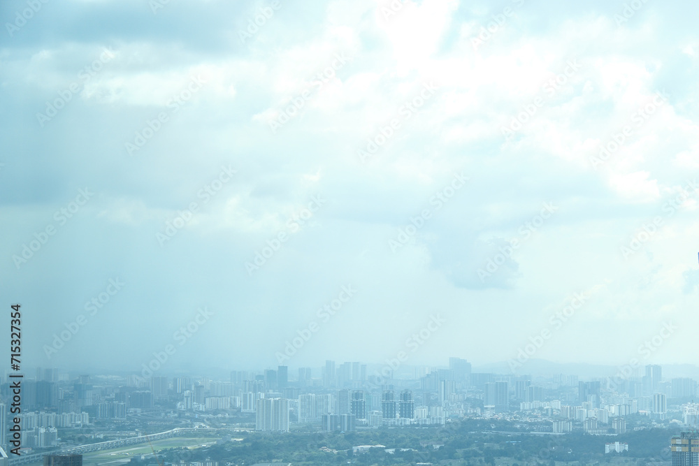 Cityscape skyline with clouds in sky.