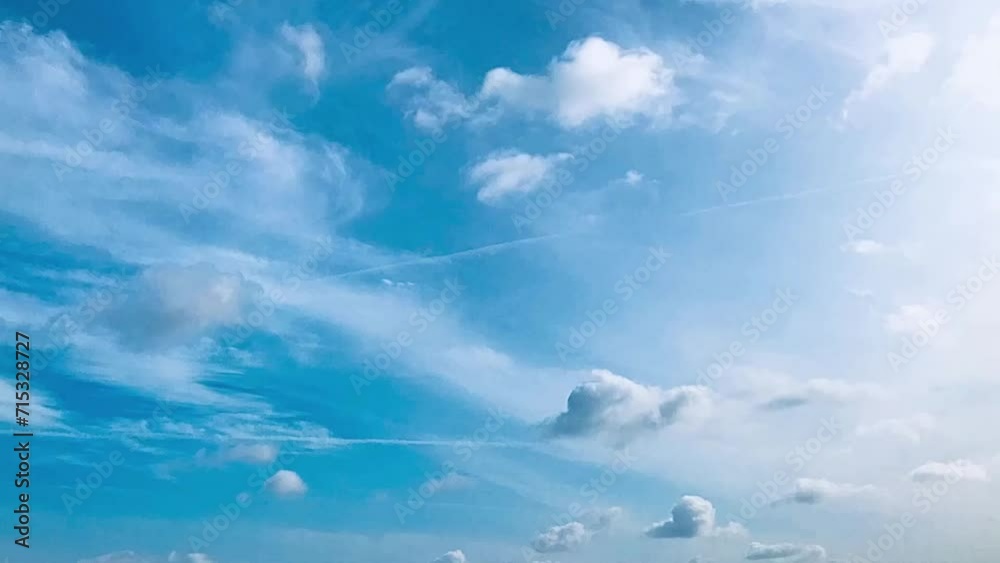 Time lapse clouds and bright blue sky, circle of white clouds over blue sky with sunlight, time lapse video of clouds in motion, blue sky nature bright white weather.