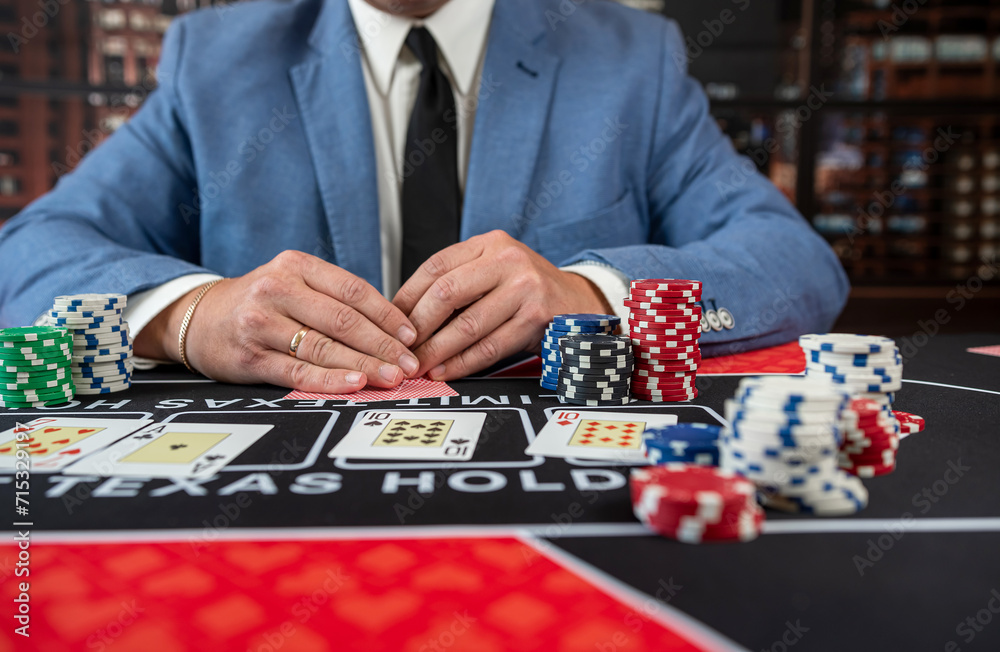 Male player hold poker card play a game for chance to win at casino. Male player hold poker card play a game for chance to win at casino.
