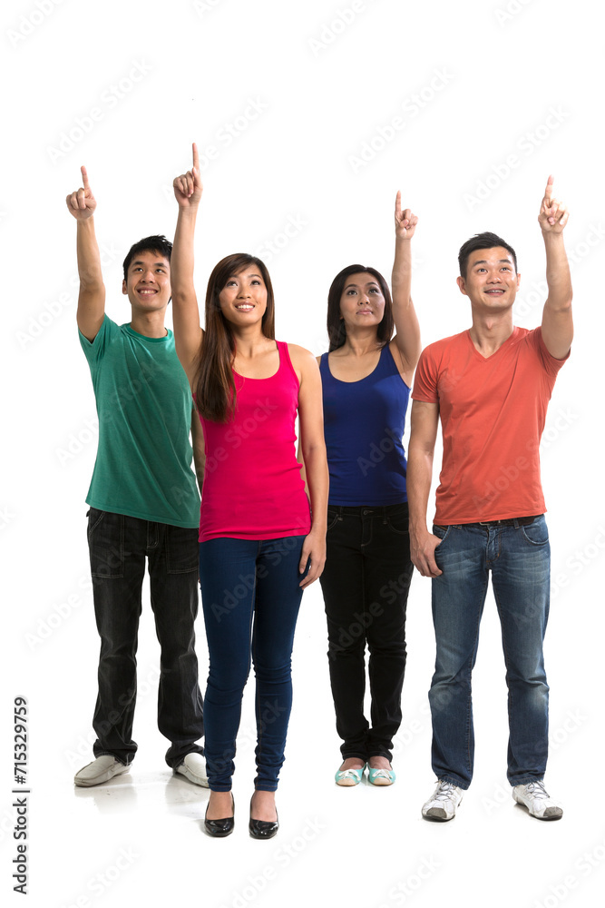 Group of happy Chinese friends pointing upwards. Group of happy Chinese friends pointing upwards.