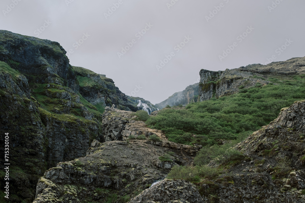 Moody green and rocky hiking trail to Glymur waterfall