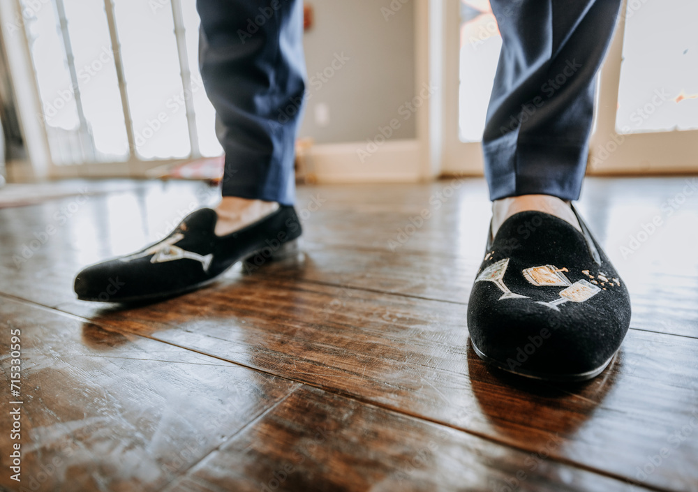 close up of groom in his black velvet wedding shoes close up of groom in his black velvet wedding shoes