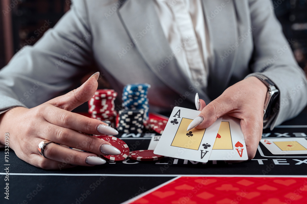 female player shows winning combination of two aces, win in casino poker female player shows winning combination of two aces, win in casino poker