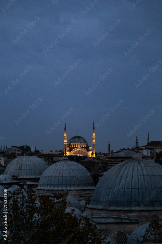 Three domes and a mosque lighted up in Istanbul