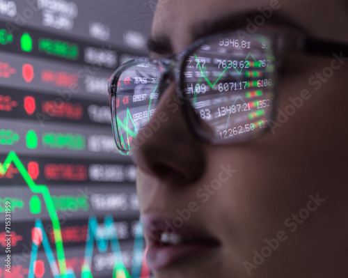 Female analyst viewing financial performances on screen