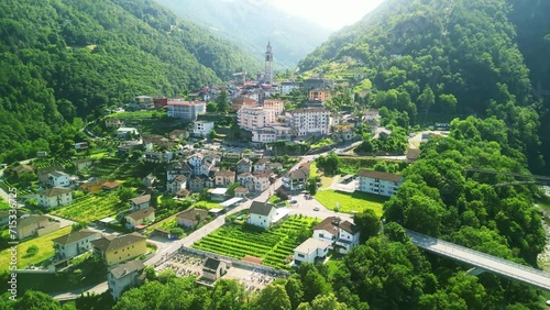 Aerial drone view of scenic swiss train Vigezzina-Centovalli Railway in Intragna village. between Domodossola and Locarno. Ticino Switzerland. Swiss Alps in summer, 4k. photo