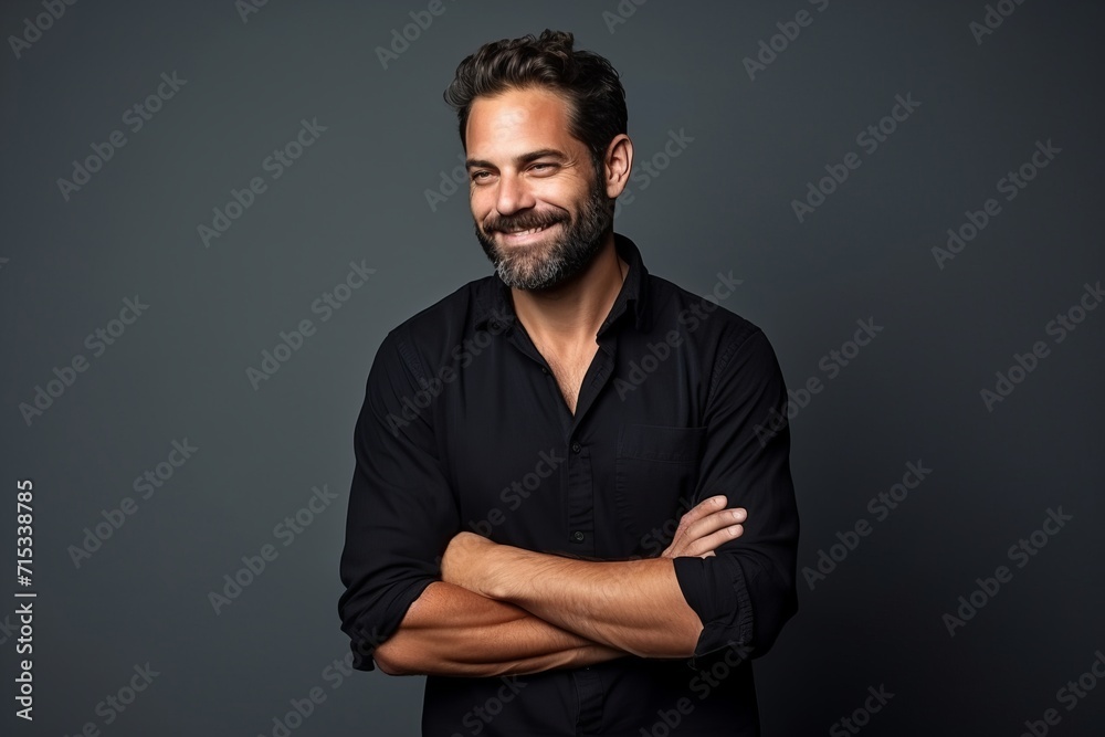 Handsome middle age man with beard and mustache in black shirt over grey background. - obrazy, fototapety, plakaty 