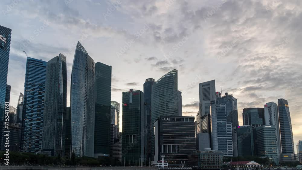 Timelapse Day to Night of Singapore City Skyline and Financial district across Marina Bay under a beautiful sky and light in Singapore. Time lapse Day to Night City. Timelapse Day to Night of Singapore City Skyline and Financial district across Marina Bay under a beautiful sky and light in Singapore. Time lapse Day to Night City.