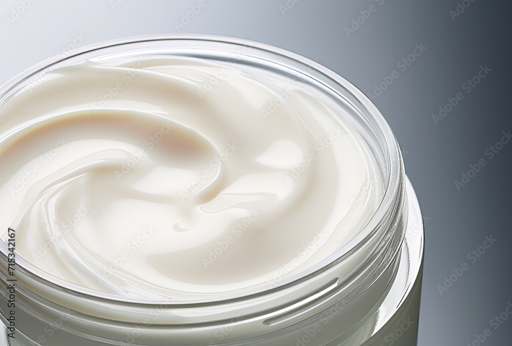 Gray background enhances the allure of cosmetic cream in a jar, providing generous copy space for product details. Gray background enhances the allure of cosmetic cream in a jar, providing generous copy space for product details.