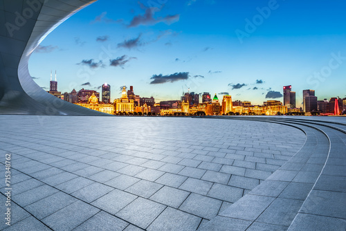 Empty square floor and city skyline with modern buildings scenery at night in Shanghai. Famous Bund landmark in Shanghai.