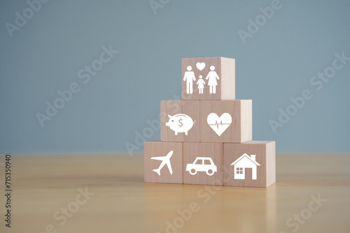 Insurance concept. Protection against a possible eventuality. House, savings, car, family, travel and health care on wooden block for Life assurance concept. photo