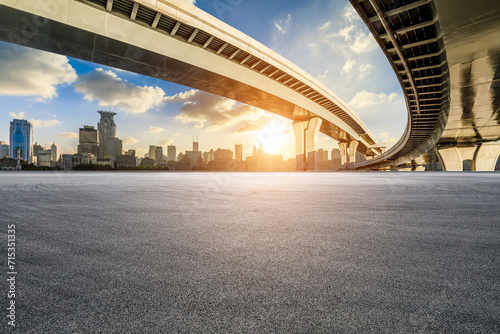Asphalt road square and bridge with city skyline at sunset in Shanghai photo