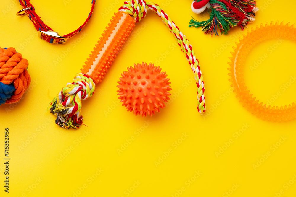 Fototapeta premium Pet toys on yellow background studio shot