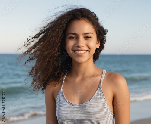 Smiling latin hispanic girl standing at the beach