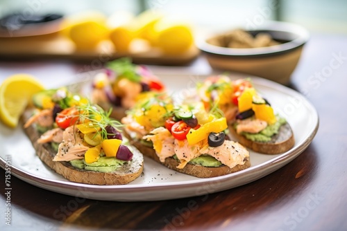 open-faced baked salmon sandwiches on a platter