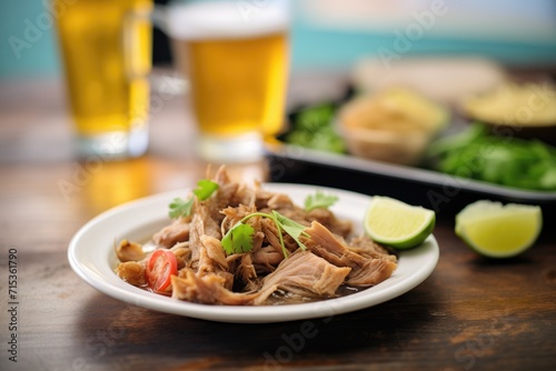 beer-braised carnitas with a pint of lager in the background