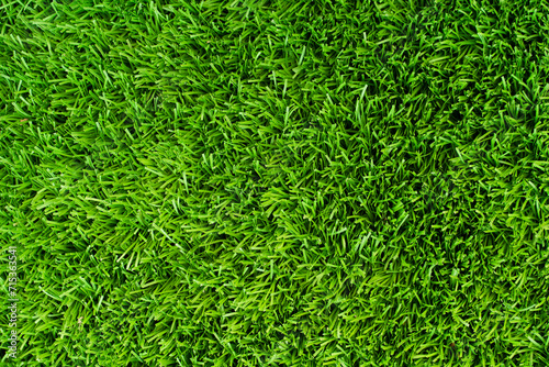 Top of view Close up of vibrant green artificial grass turf in residential. photo
