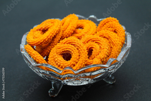 Indian snacks food murukku in a glass bowl  photo