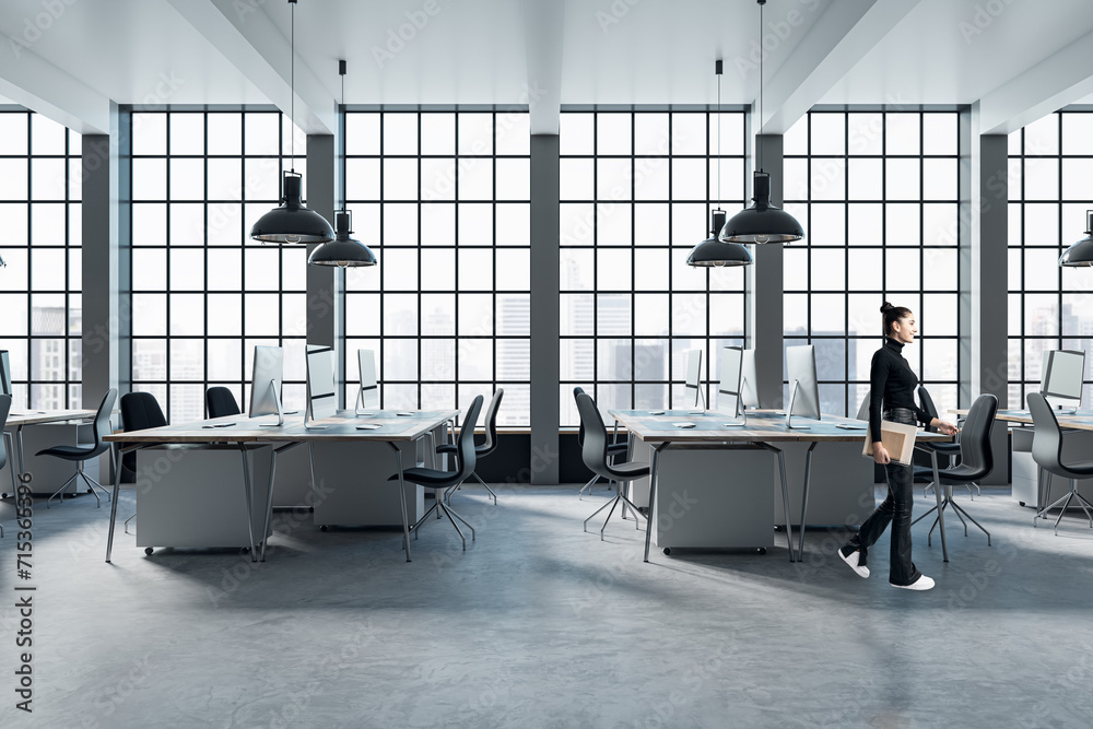 © Who is Danny - Pretty blurry woman walking in modern coworking office interior with large panoramic windows with city view, lamps, concrete flooring and other objects.