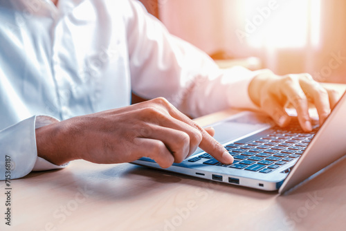 Businessman hand typing on computer keyboard of a laptop computer in office. Business and finance concept. uds © Summit Art Creations