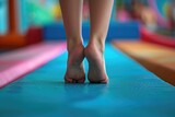 Feet Of Young Gymnast On Balance Beam.