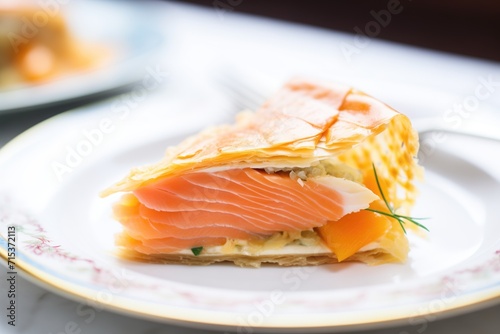 close-up of a sliced salmon en croute on a white plate