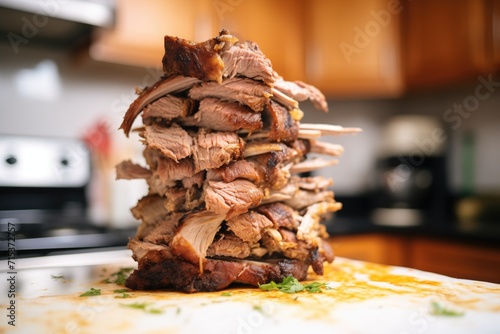 stacked spiced shawarma meat before grilling, close-up in kitchen