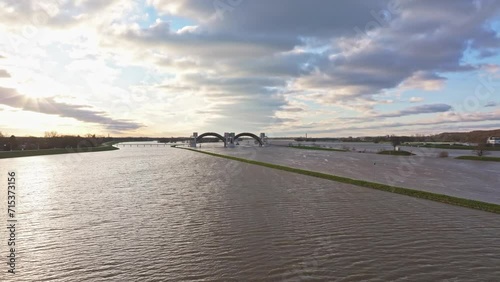 Approach drone shot of the weir of Driel during high water levels during the sunset photo