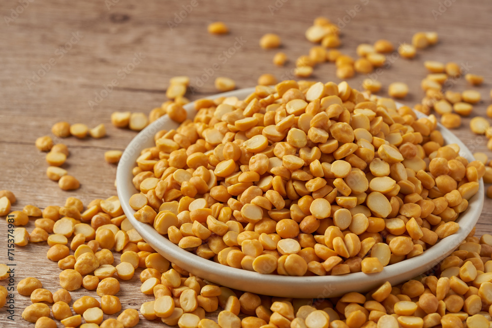 close up split bengal gram or chana dal in bowl on wood table rustic food background close up split bengal gram or chana dal in bowl on wood table rustic food background