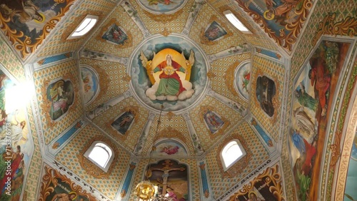 Painting of the dome in the middle of the church. Interior of the temple. Slow motion.
