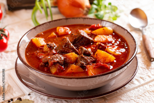 Beef goulash, soup and a stew, made of beef steak, potatoes and plenty of paprika. Hungarian traditional meal, typical Czech food