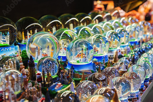 Glass souvenir snow balls with miniature Blue Mosque and Hagia Sophia inside. Street shop with gifts and souvenirs. Istanbul, Turkey photo