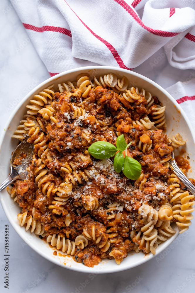 Vegetarian bolognese sauce with lentils and whole wheat pasta on a plate Vegetarian bolognese sauce with lentils and whole wheat pasta on a plate