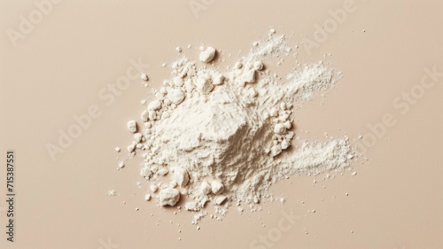 White flour on the beige background. Baking powder.