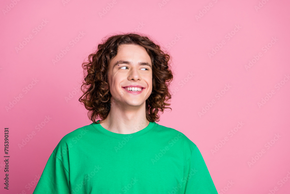 Portrait of teenage boy with piercing on his face smiling looking empty space idea make his first money isolated on pink color background