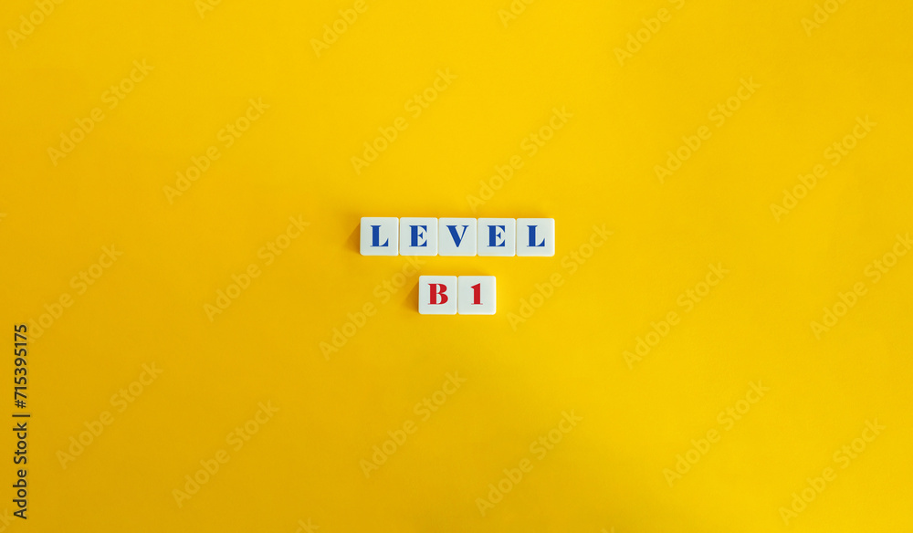 Level B1 Word and Banner. Block Letter Tiles on Yellow Background. Minimalist Aesthetic. Level B1 Word and Banner. Block Letter Tiles on Yellow Background. Minimalist Aesthetic.