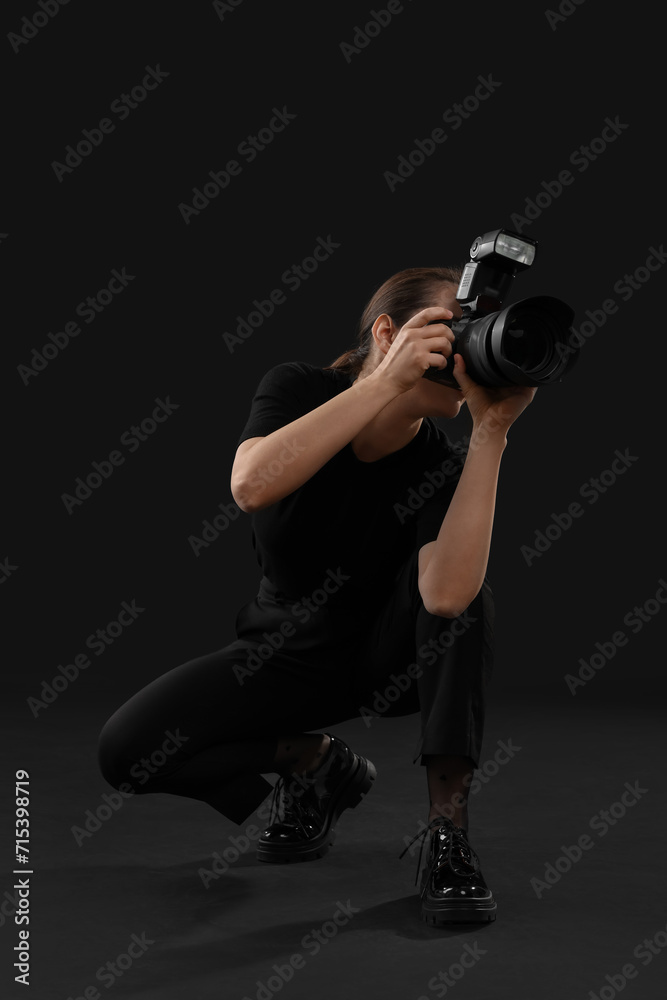 Professional photographer taking picture on black background Professional photographer taking picture on black background