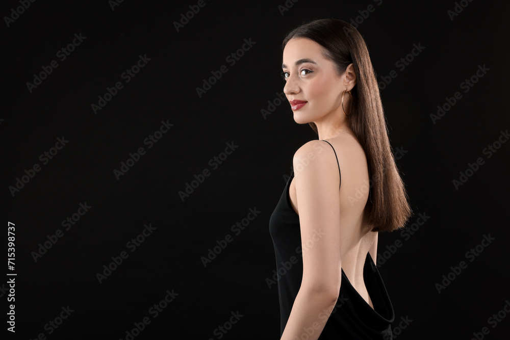 Beautiful young woman on black background, space for text Beautiful young woman on black background, space for text