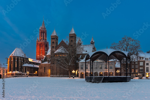 Maastricht  Netherlands 01-19-2024 Basilica of Saint Servatius and the Vrijthof square during twilight  covered with fresh snow in January.  