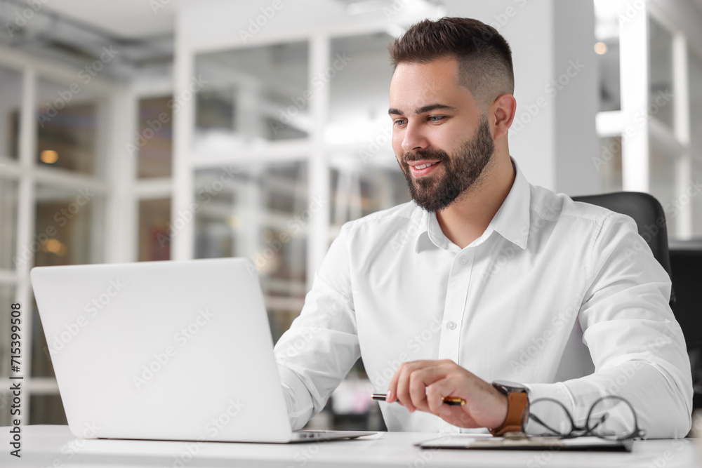 Smiling man working at table in office. Lawyer, businessman, accountant or manager Smiling man working at table in office. Lawyer, businessman, accountant or manager