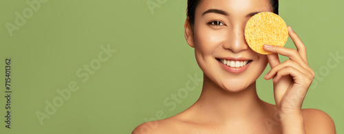 Skin care cleansing. Hygiene. Beauty treatment and skincare. Oil control. Beautiful Asian model using sponge for clear her face.