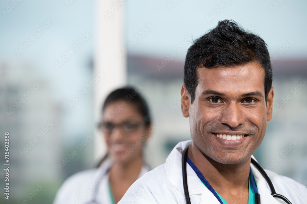 Male Indian doctor standing with his colleague Male Indian doctor standing with his colleague