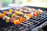 beef teriyaki and vegetable kabobs on a charcoal grill