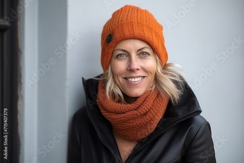 Portrait of a beautiful middle aged woman in a warm hat and scarf